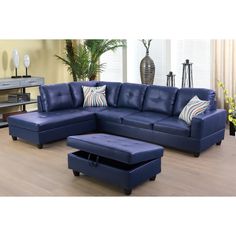 a blue leather sectional sofa with ottoman and footstool in front of a window