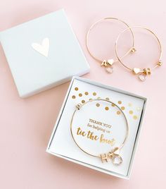 "Bridal Party Bracelets are a unique jewelry gift gift for your bridesmaids and maid of honor - your gals will fall in love with these Gold Personalized Bracelets - pretty bangles have a clear diamond like charm, heart charm & a single monogram initial - all 18k gold plated. For a perfect package choose to add a pretty heart topped gift box to your order. Details 1 Monogram Bracelet Listing is for 1 monogram bracelet - you can ADD a gift box of your choice at checkout for an additional price Bridal Party Gifts For Bridesmaids, Inexpensive Bridesmaid Gifts, Bridal Party Bracelets, Gold Bridal Party, Initial Bangle Bracelet, Party Bracelets, Bridesmaid Bracelet Gift, Initial Bracelet Gold, Gifts For Bridesmaids