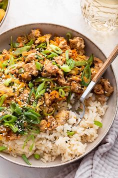 a bowl filled with rice, meat and veggies