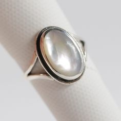 "All Sterling Silver items in our shop are stamped 925, lead and nickel free, solid 925 silver, NOT plated or filled. Mother of Pearl 925 Sterling Silver Handmade Ring Genuine Mother of Pearl with Rainbow reflection June Birthstone  Fast shipping from USA!  Exquisite craftsmanship!  Finest quality sterling silver 925.    Length: 5/8\" Width: 3/8\" Mother of Pearl is a June birthstone, and is considered by many to bring protection and calming effects to the wearer. Stamped .925 sterling silver. Mother Of Pearl Rings, Rainbow Reflection, Pearl Rings Vintage, Mother Of Pearl Ring, Silver Rings Simple, Silver Items, Jewelry Lookbook, June Birthstone, Packaging Box