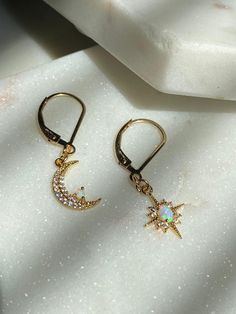 Moon and Star Opal Earrings-Gold Filled Earring Clasps-Dangle Earrings-Celestial Earrings-Gold Moon Earrings-Gold Star Earrings-Opal Earring~~~~~~~~~~~~~~~~~~~~~~~~~~~~~~~~~~~~~ITEM DETAILS* * Gold Plated Opal Moon 8x13mm* * Gold Plated Opal Star 10x13mm* * 14k Gold Filled Leverback earrings🔔✨🔔 Claim your 10% Coupon by signing up to our mailing list (copy and paste link on URL) https://www.subscribepage.com/pinkslate  🔔✨🔔--SHIPPING DETAILS--*No Invoices are included in the package*If standar Celestial Star-shaped Earrings For Pierced Ears, Celestial Star-shaped Crystal Earrings Gift, Celestial Star-shaped Crystal Earrings For Gift, Gold Moon-shaped Celestial Crystal Earrings, Celestial Star-shaped Crystal Earrings, Celestial Gold Moon-shaped Crystal Earrings, Celestial Drop Earrings With Star Charm, Celestial Moon Shaped Earrings With Star Charm, Celestial Star Charm Round Earrings