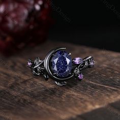 Oval cut Blue Sandstone engagement ring set unique Moon style amethyst cluster ring gothic black gold rings for women leaf branch rings -----Ring Information----- ✦Engagement Ring Metal Type: 925 sterling silver, 10K/14K/18K Solid Gold, Platinum Center stone: Blue sandstone Stone size: 6x8mm oval cut Side stone: amethyst ✦Wedding Band Stone: Round amethyst  ✦ Please feel free to contact me if you have any questions or you are interested in custom order. ✦Black rhodium plating: Rhodium, a valuabl Celestial Metal Ring Jewelry, Celestial Style Metal Ring Jewelry, Black Birthstone Jewelry For Promise Ring, Elegant Crescent-shaped Birthstone Jewelry, Elegant Crescent Shaped Birthstone Jewelry, Elegant Crescent Birthstone Jewelry, Celestial Style Metal Ring As Gift, Gothic Purple Metal Jewelry, Oval Gemstone Gothic Jewelry