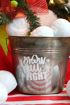 a bucket filled with cotton balls on top of a red and white striped table cloth