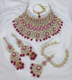 Description: Enhance your elegance with this stunning Traditional Indian Kundan Necklace Set featuring matching earrings, meticulously crafted to perfection. This exquisite jewelry set is the epitome of luxury, blending traditional design with contemporary flair, making it a must-have for every jewelry collection. Product Features: Material: High-quality Kundan stones, gold-plated alloy, and pearl detailing. Design: Intricately designed with a beautiful combination of beads that add a pop of color, perfect for any occasion. Earrings: Matching earrings with a comfortable fit, complementing the necklace perfectly. Necklace Length: Adjustable with a drawstring closure to suit your neckline and preference. Occasion: Ideal for weddings, bridal wear, engagements, festive occasions, and parties. Kundan Choker Necklace, Earrings Matching, Kundan Necklace Set, Kundan Choker, Kundan Necklace, Bollywood Jewelry, Necklace Bridal, Kundan Necklaces, Indian Bollywood