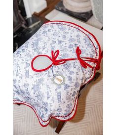 a cushion with a red ribbon tied around it