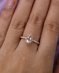 a woman's hand with a pink diamond ring on her left hand, and an engagement