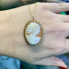 Metal: 14kt Yellow Gold Stone: Shell Shape: Oval Weight of entire piece with chain: 6.60 grams Length Of Cameo Including Bail: 33.00 mm Width Cameo : 23.00 mm Closer Type: Pin Stem With Side Catch Closer Age: Vintages, approximately from the 1960's. Type Of Chain: Rolo Chain Width Of Chain: 1.00mm Type Of Lock: Lobster Lock Length Of Chain: 18inches Jewelry Type: The back on this cameo has a pin to wear it as a brooch, as well as a loop that folds back and forth wear it as a pendant, on a chain. Elegant Cameo Jewelry For Formal Occasions, Antique Yellow Gold Necklace With Cabochon, Classic Cameo Necklace As Gift, Classic Cameo Necklace For Gift, Luxury Gold Cameo Necklace, Elegant Cameo Necklace For Formal Occasions, Formal Yellow Gold Cameo Jewelry, Cameo 14k Gold Round Jewelry, Classic Yellow Gold Necklaces With Cabochon