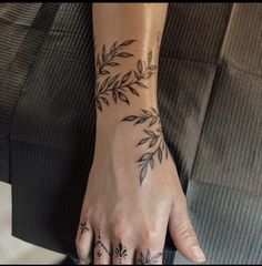 a woman's hand with tattoos on it