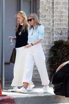 two women walking down the street together