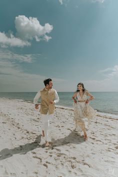 a man and woman are running on the beach