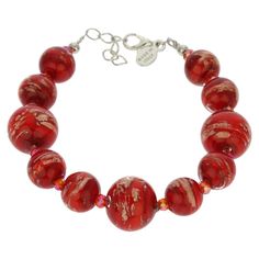 This gorgeous Venetian bracelet in rich fire red color is handcrafted on Murano Island in the glassworks of famous Murano glass masters whose craftsman lineage goes back centuries. It is is 100% hand-crafted using ancient Murano glass techniques. The bracelet features round beads of varying sizes generously infused with Avventurina sparkles for a unique shimmering look. Its festive style is sure to bring a touch of Venetian sun and opulence into your life. This Murano bracelet is a must-have for Red Czech Glass Bracelet For Gift, Adjustable Red Czech Glass Bracelet, Adjustable Red Czech Glass Bracelets, Red Murano Glass Jewelry For Jewelry Making, Red Czech Glass Jewelry, Red Czech Glass Bracelet, Red Czech Glass Bracelet With Round Beads, Handmade Red Glass Beaded Bracelets, Artisan Red Adjustable Bracelet