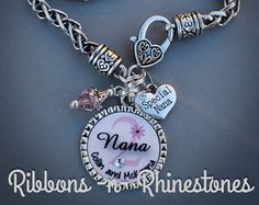 a charm bracelet with a name on it and charms attached to the front of it