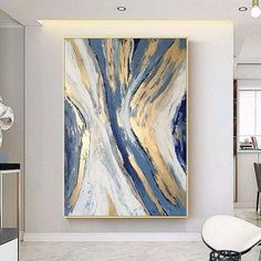 an abstract painting hangs on the wall above a dining room table and chairs in front of it