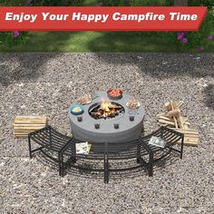 a fire pit sitting on top of a gravel field next to two chairs and a table