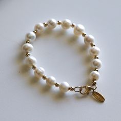 "The Real Pearl Bracelet is a beautiful bead bracelet that brings a touch of elegance and charm to your wrist. Made from genuine Gemstone beads,  This  Freshwater Pearl Bracelet showcases the beauty of natural Stone crystals, and when paired with a beautiful gold Link Chain, it creates a beautiful and harmonious look. This Delicate Bracelet is made with genuine Stone. Real Pearl is a natural gemstone that comes from the earth and is of the highest quality and authenticity. Recall your fondest beach memories with the luxurious Bora Bora Pearl bracelet. This bracelet features 10mm genuine cultured freshwater pearls paired with 14k gold accents and is made to order. Please allow 1 to 5 business days for fulfillment. 🌟 Product Details 🌟  Sizes: 7\", 8\", 8.25\", 8.5\", 9\" Metal options: 14k Classic Everyday Beaded Bracelets With Pearl Charm, Elegant Silver Name Bracelet With Round Beads, Elegant Pearl White Beaded Bracelets With 8mm Beads, Single Strand Pearl Bracelet With Round Beads, Pearl White Single Strand Beaded Bracelets, Single Strand Round Pearl Bracelet, Pearl White Beaded Bracelet, Pearl White Single Strand Beaded Bracelet, Elegant Pearl White Stretch Bracelet