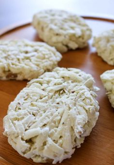 several biscuits are arranged on a wooden plate