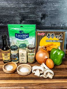 an assortment of ingredients are displayed on a wooden counter top, including mushrooms, garlic, and seasonings