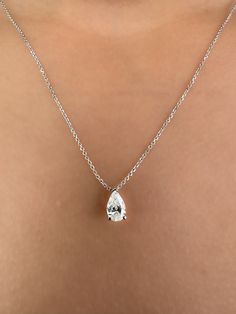 This Beautiful timeless floating diamond pendant is set with a lab-grown pear-shaped diamond in 14k solid gold. The photos show a 0.75ct pear-shaped lab-grown diamond. All of our diamonds are high-quality D color, VS1 clarity. Each diamond is securely set in a Prong setting, radiating sophistication with every glance. Every diamond is expertly positioned to reflect maximum light and brilliance that tells your forever love story. The pendant and chain are made of 14k solid gold and feature a spring clasp. Designed for comfort, this pear diamond necklace can easily be layered with other necklaces. This necklace is sure to bring a smile to her face and become a cherished addition to her jewelry collection. Our collection offers a variety of sizes and carat weights to suit diverse preferences. Formal Pear-shaped Diamond Cut Drop Necklace, Elegant Pear Shaped Drop Necklace With Brilliant Cut, Elegant Pear-shaped Drop Necklace With Brilliant Cut, Classic Brilliant Cut Drop Necklace For Formal Occasions, Elegant Pear-shaped Brilliant Cut Drop Necklace, Classic Teardrop Diamond Necklace For Wedding, Timeless Pear-shaped Diamond Necklace For Wedding, Pear-shaped Diamond Necklace For Wedding, Classic Pear-shaped Diamond Drop Necklace