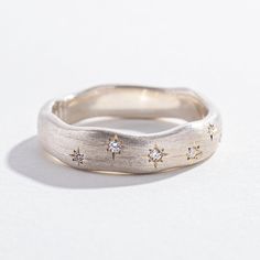 Reminiscent of the night sky, Angela Monaco's Starry Night ring has just the right amount of twinkle. This ring contains 8 pavé-set diamonds, scattered along the front length of the band. The brushed metal effect makes this ring versatile enough to wear alone, stacked, or paired as a wedding set. Available in brushed Sterling Silver. Details (4) 1.3mm white diamonds (4) 1mm white diamonds Constellation Ring, Clay Silver, Ring Inspo, Jewelry Lookbook, The Night Sky, Wedding Set, Brushed Metal, Men's Ring, Girly Jewelry