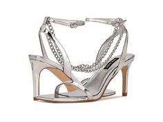 Nine West Tallo 3 - Women's Shoes : Silver : Feel like an absolute diva when you slay in the sexy Nine West Tallo 3 strappy sandals. Faux leather upper. Man-made lining. Open square toe. Metallic chain embellishment. High heels. Ankle strap with buckle closure. Man-made outsole. Imported. Weight of footwear is based on a single item, not a pair. Multi-strap Party Sandals For Summer, Summer Party Sandals With Multiple Straps, Strapped Sandals With Heel Strap For Evening, Open Toe Heels With Chain Strap For Party, Chain Strap Open Toe Party Heels, Chain Strap Open Toe Heels For Parties, Trendy Evening Sandals With Straps, Party Open Toe Heels With Chain Strap, Party Heels With Chain Strap And Open Toe