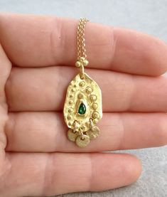 Boho gold necklace 9k 14 k Solid gold necklace with green emerald May birthstone, Yellow gold necklace, Delicate Pendant, Gift for her This solid gold necklace has a rustic textured and is set with a natural green emerald. The pendant has a delicate granulation all around it. This pendant is delicate but has a lot of character, and will upgrade any outfit you'll wear, for everyday use, as for special occasions The pendant can be ordered without the chain too. An excellent choice for anniversary Gold Necklace Delicate, Delicate Pendant, Solid Gold Necklace, Yellow Gold Necklace, Dainty Gold Necklace, May Birthstone, Oval Pendant, Green Emerald, Minimalist Necklace