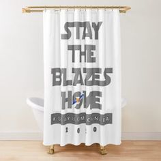 a white shower curtain with the words stay the blazes home on it