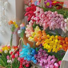 colorful tulips and other flowers on display at a flower shop in the city