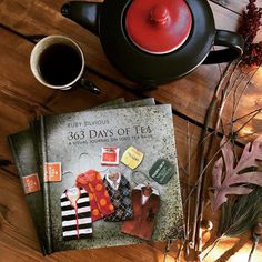 there is a tea pot and two books on the table