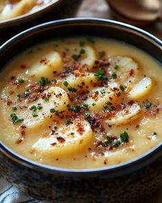 two bowls filled with soup on top of a table