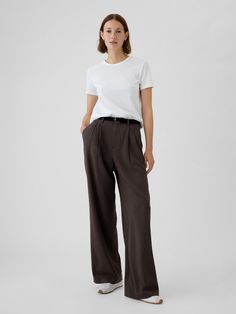 Soft, warm brushed twill trousers.  E-waist with concealed hook and bar closure, zip fly.  Front slant pockets, back welt pockets.  Pleating at front.  Fit: Classic.  An easy silhouette that fits close at the waist, and is relaxed through the hips and thigh.  Models wearing Gap Trousers Outfit Winter, Brown Trousers Outfit, Taupe Trousers, Cotton Trousers Women, Fw 2024, Fall Winter Capsule Wardrobe, Wide Leg Pants Women, Easy Silhouette, Work Fits