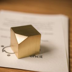 a gold ring sitting on top of a piece of paper