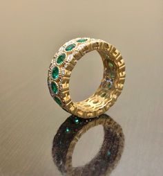 DeKara Designs Collection Metal- 18K Yellow Gold, .750. Stones- 17 Genuine Round Emeralds 1.90 Carats, 102 Round Diamonds F-G Color VS1 Clarity 0.42 Carats. Entirely Handmade 18K Yellow Gold Eternity Diamond Round Emerald Engagement Band. This band is extremely elegant featuring round fiery, and beautiful green emeralds that are all professionally burnish set individually with amazing bead work surrounding each stone. There are 51 professionally pave set round diamonds on the top and bottom of b Emerald Wedding Jewelry With Pave Setting, Luxury Cubic Zirconia Bridal Set For Anniversary, Luxury Wedding Rings With Hand Set Details, Luxury Diamond Bridal Sets, Luxury Gold Bridal Sets With Diamonds, Luxury Yellow Gold Bridal Sets, Luxury Moissanite Wedding Ring, Luxury Hand Set Rings For Wedding, Luxury Hand Set Bridal Sets