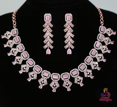 Extremely Beautiful American diamond necklaces studded with high quality CZ color stones. This luxurious look diamond replica necklace crafted in rose gold polish studded with high quality lab created diamond crystals. length of the earrings : 2.25 Inches Weight of the Earring : 0.2 Oz Weight of the necklace : 1.75 Oz Length of the necklace is 8 Inches And the chain extenders are 8 inches. The total length of the necklace is 16 Inches. Dazzling Rose Gold Diamond Jewelry Sets, Rose Gold Crystal Necklaces With Diamond Accents, Party Diamond Cut American Diamond Necklace, Party American Diamond Cut Necklace, Rose Gold Diamond Cut Jewelry For Party, Rose Gold Diamond Jewelry Sets For Party, Dazzling American Diamond Necklaces With Stone Setting, Pink Diamond Jewelry With Stone Setting, Rose Gold Cubic Zirconia Diamond Necklace For Party