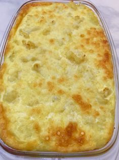 a casserole in a plastic container on a white tablecloth covered table cloth