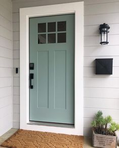 a blue front door on a white house with the words exterior paint written above it