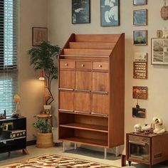 a living room filled with furniture and pictures on the wall