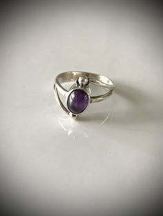 This vintage sterling silver and amethyst ring is perfect for any vintage jewelry enthusiast! Delicate and beautiful and the cabochon stone is secure in its setting. Measures about 5 1/2-5 3/4 abs is a lovely little treasure! Thanks guys looking and please check out my shop for more wearable heirloom quality vintage jewelry! Collectible Oval Cabochon Amethyst Ring, Polished Vintage Amethyst Ring, Vintage Silver Amethyst Ring Birthstone, Vintage Amethyst Rings With Polished Finish, Classic Amethyst Oval Cabochon Ring, Vintage Amethyst Sterling Silver Ring, Vintage Amethyst Oval Cabochon Ring, Classic Silver Amethyst Oval Cabochon Ring, Classic Amethyst Cabochon Ring