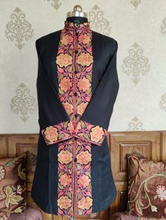 Kashmir Woolen Jacket, Ethnic Coat, Floral Coat A Kashmiri Jacket Which Can be customised according to your preference ; A Woolen Kashmiri Jacket with Aari Embroidery  This Kashmiri jacket Makes you stand apart with its vivid colours and paisley embroidery, The base colour is Black and brown Paisley-Aari Embroidery is done all over the jacket, the material used is of high-quality wool and the embroidery is done by brilliant Kashmiri artisans.  Embroidery      Floral Aari Work Length Traditional Sherwani With Floral Embroidery, Traditional Black Sherwani With Floral Embroidery, Ceremonial Bandhgala With Floral Embroidery, Eid Kurta With Floral Embroidery And Stand Collar, Traditional Kurta With Chikankari Embroidery And Stand Collar, Ceremonial Bandhgala With Floral Embroidery For Festivals, Traditional Fitted Outerwear With Floral Embroidery, Fitted Nehru Jacket With Floral Embroidery, Fitted Nehru Jacket With Floral Embroidery And Stand Collar