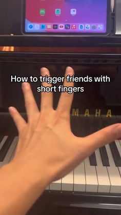 someone is playing the piano with their hand and fingers in front of an electronic keyboard