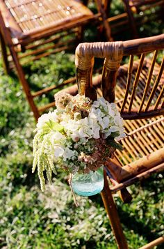 a bouquet of flowers is sitting on an old chair