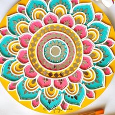 an intricately designed paper plate with markers