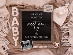 a baby announcement is displayed on a blanket