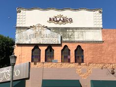 an old brick building with arched windows and a sign that says brago on the side