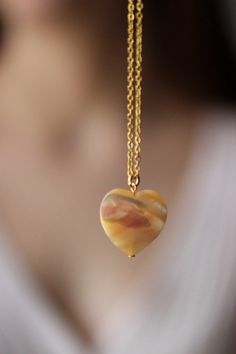 This delicate unique necklace was made of natural mother of pearl beige heart pendnat and high quality gold tone stainless steel chain with gold tone lobster claw. The chain is from lead & nickel free metal. Perfect jewelry for everyday wear and a great gift for someone special! The length of necklace is 45 cm or 17.7 inches. Other necklaces of my shop you can see here: https://www.etsy.com/shop/NaTavelli?section_id=14843046&ref=shopsection_leftnav_5 Thanks for a visit. Agate Pendant Necklaces With Adjustable Chain, Agate Pendant Necklace With Adjustable Chain, Jade Pendant Necklaces For Crafting, Elegant Heart Pendant Jewelry For Healing, Gold Chalcedony Jewelry As A Gift, Resin Pendant Necklace With Lobster Clasp, Gift Necklaces With Round Beads And Heart Charm, Gift Necklace With Heart Charm And Round Beads, Elegant Agate Jewelry With Adjustable Chain