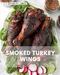 smoked turkey wings on a plate with spinach and radishes next to it