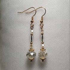 These are long unique genie or perfume bottle style earrings. they are made with crystal glass beads and silver and gold pated metal accents. These ae light long and flirty and would go with any out fit for any occasion! We can make these in almost any color so if you cant find it made on our page please put in a custom request!These would make a unique addition to anyone's jewelry collection and great gifts for friends and family! Gold Beaded Earrings With Faceted Beads For Gifts, Elegant Nickel-free Beaded Earrings For Festive Occasions, Elegant Festive Beaded Earrings Nickel Free, Elegant Gold Crystal Earrings With Dangling Beads, Elegant Festive Nickel-free Beaded Earrings, Gold Spiritual Beaded Earrings For Gifts, Gold Crystal Earrings For Celebration, Gold Spiritual Crystal Earrings For Gift, Gold Spiritual Drop Crystal Earrings