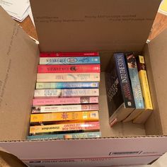 a cardboard box filled with lots of books