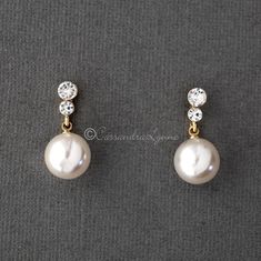 A larger pearl drop earring set of light ivory pearls that hang from two small round crystals. A classic looking wedding day earring style! They are silver or gold plated, titanium posts, 12mm synthetic pearls and 1 inch long. Hanging Pearl Earrings, Pearl Hanging Earrings Gold, Classic Pearl Embellished Drop Earrings, Classic Pearl Bridal Earrings In Pearl White, Classic Pearl Bridal Earrings, Classic White Pearl Bridal Earrings, Classic Pearl Chain Bridal Earrings For Anniversary, Classic Bridal Earrings With Pearl Chain For Anniversary, Classic Formal Bridal Earrings With Pearl Chain