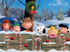 a group of cartoon characters standing in front of a christmas tree with candy canes