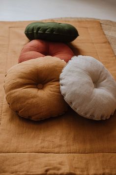 three pillows are sitting on top of a bed